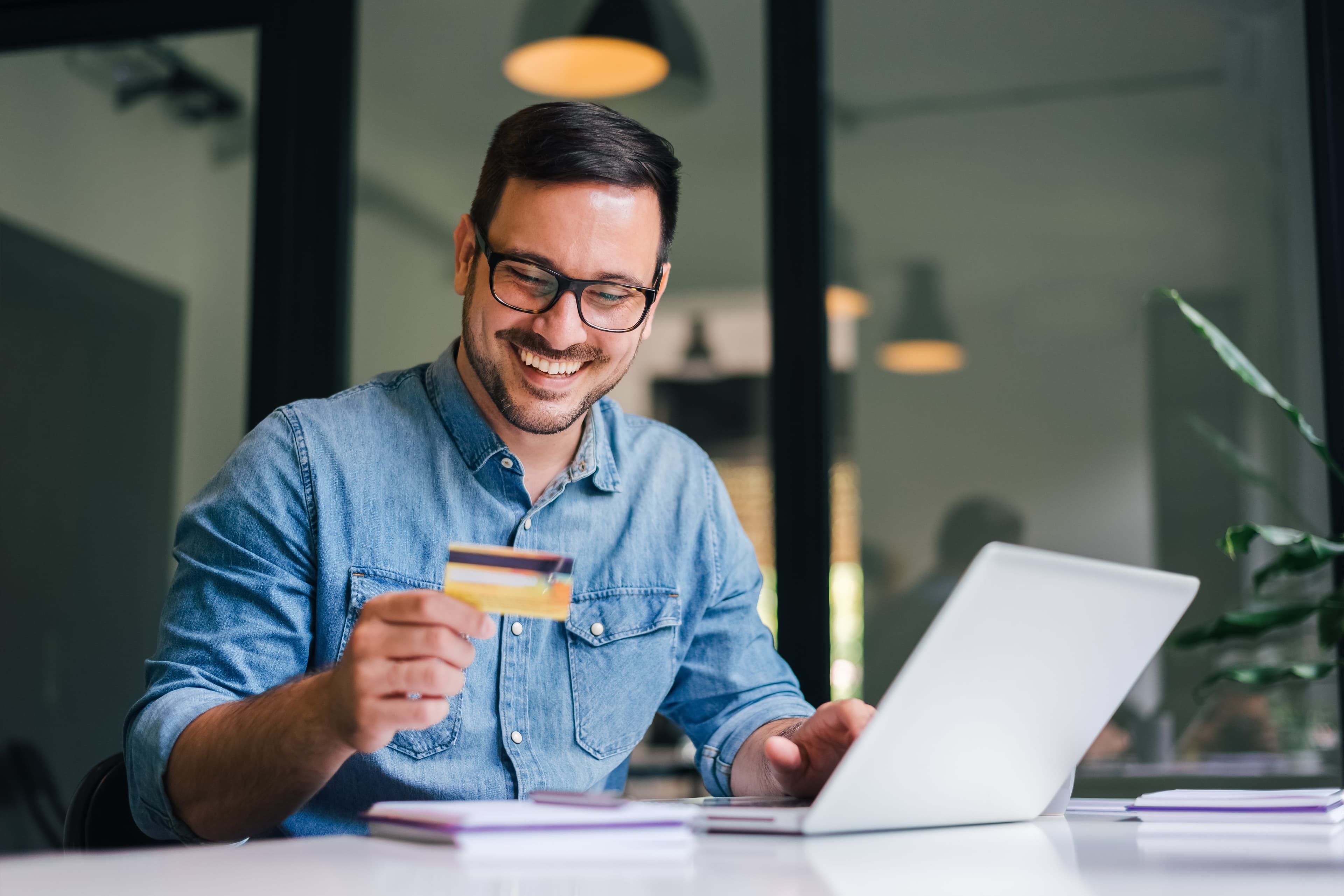 Merchant smiling while paying online with a card